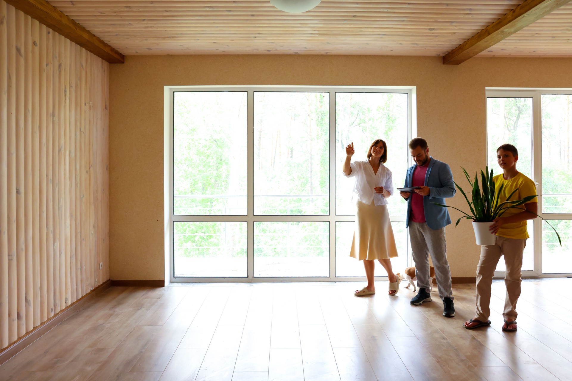 the family moves into a new apartment, inspects a new house, apartment, discusses the future interior. dad mom and son in a new empty apartment